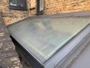 Skylight before cleaning showing algae stains