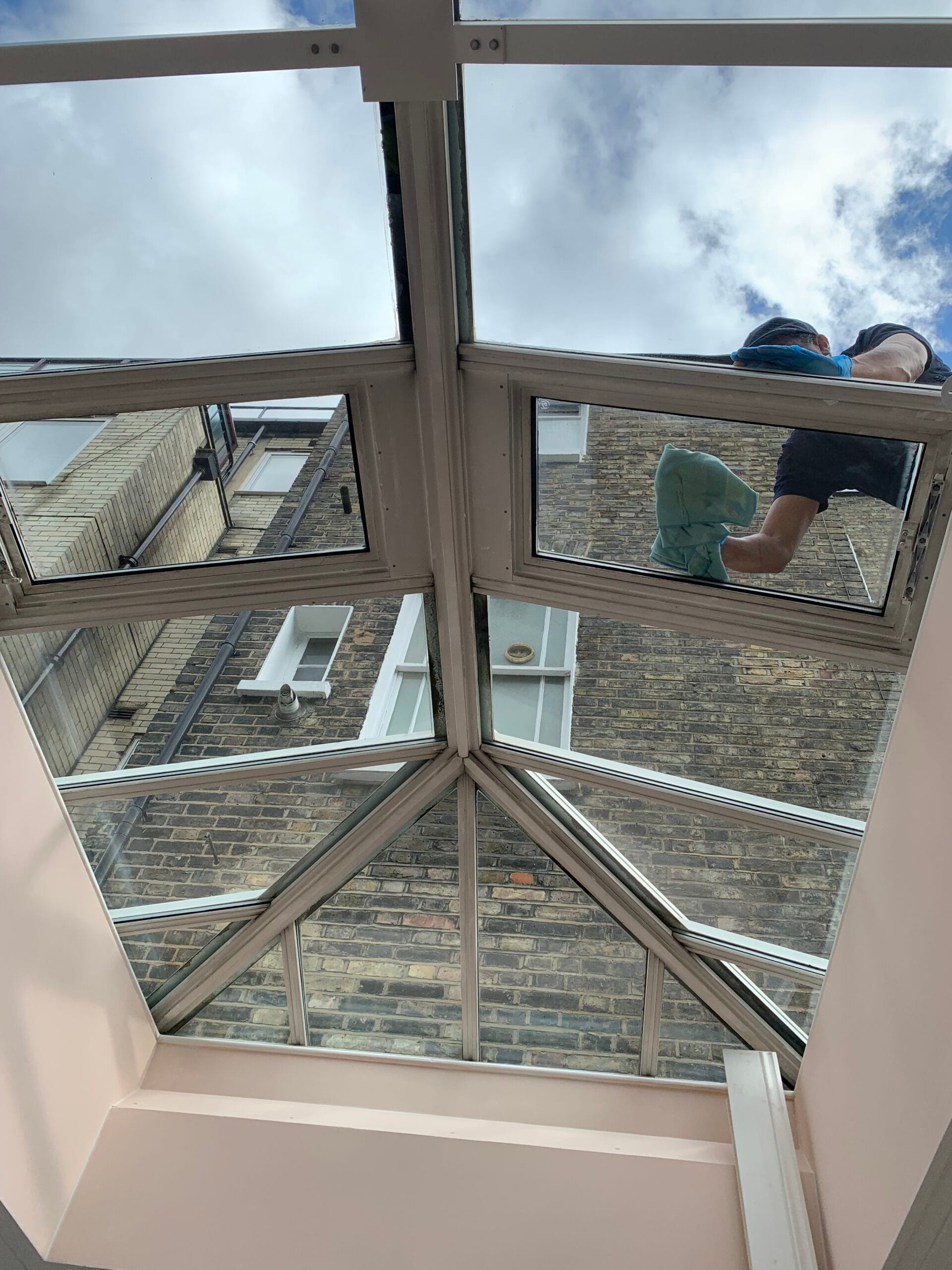 Cleaning a glass roof with professional equipment