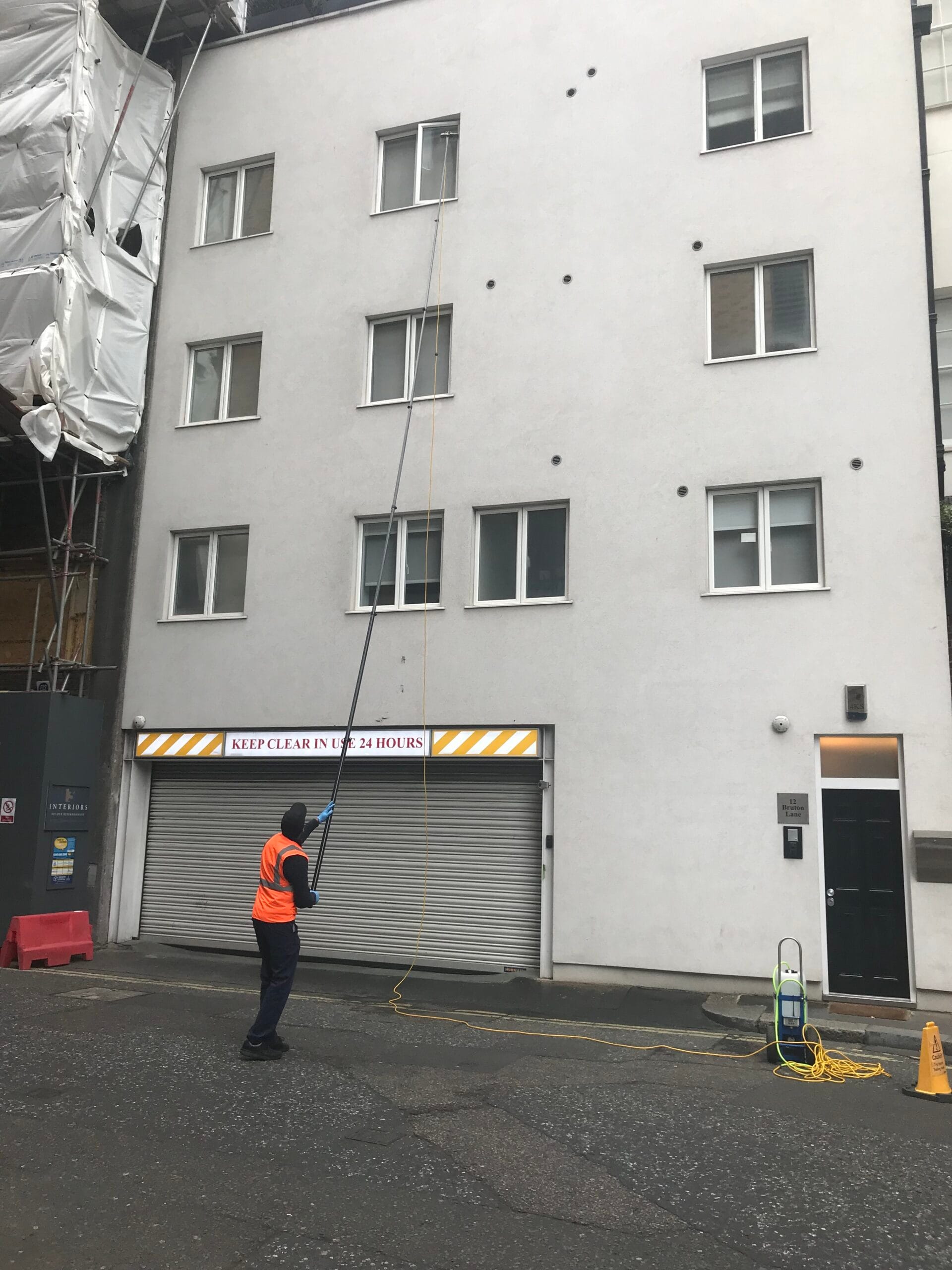 Professional window cleaners on Bruton Street, Mayfair